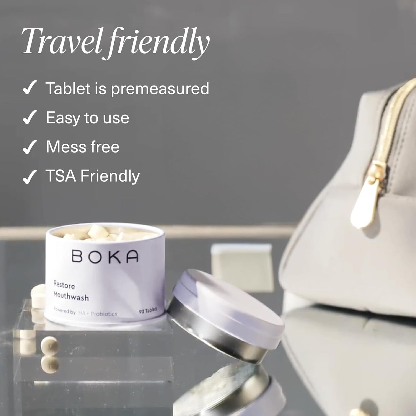 Open Restore Mouthwash Tablets beside a gray travel bag to remineralize your teeth on the go.