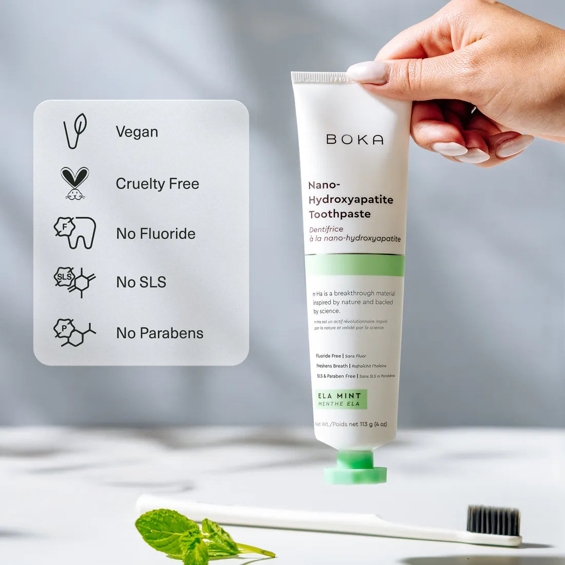 A hand holds Ela Mint n-Ha Toothpaste—vegan, cruelty-free oral care with nano-hydroxyapatite benefits.