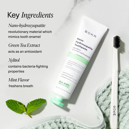 Boka Ela Mint n-Ha Toothpaste set with toothbrush, mint leaves, and key biomimetic minerals.