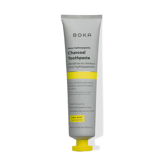 A tube of Charcoal Yuzu Mint n-Ha Toothpaste with a yellow and gray design.