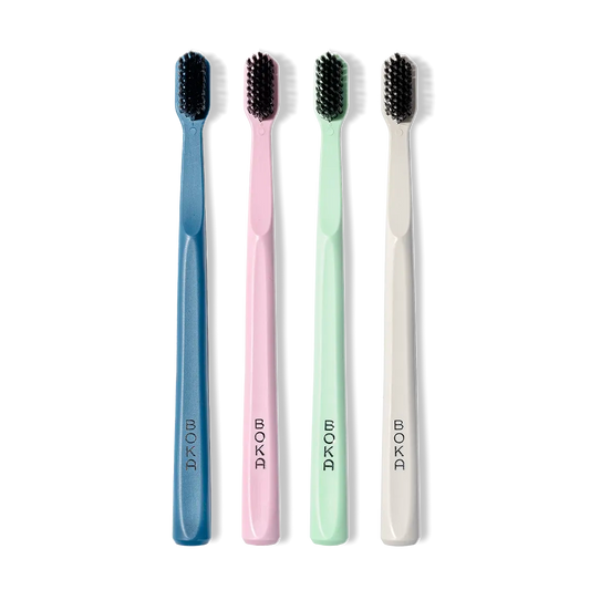 The Classic Toothbrush 4-Pack features soft bristles in blue, pink, green, and white upright brushes.
