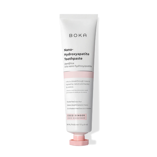A tube of Coco Ginger n-Ha Toothpaste featuring a white and pink design.