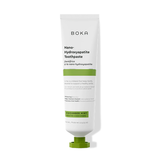 A white tube of Cucumber Mint n-Ha Toothpaste (fluoride-free) on a black background.