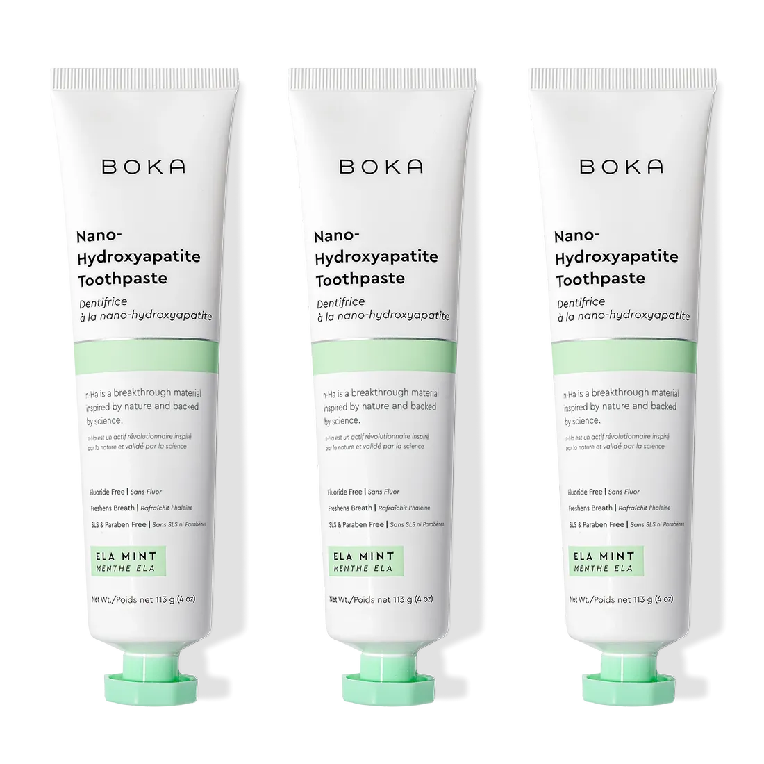 Three tubes of Ela Mint n-Ha Toothpaste stand upright, ideal for daily oral care routines.
