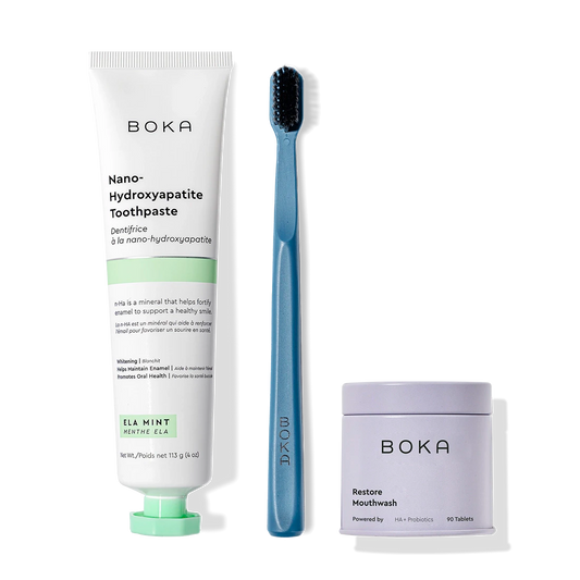 Fresh Faced Toothpaste, blue toothbrush with charcoal bristles, and Restore mouthwash tablets.