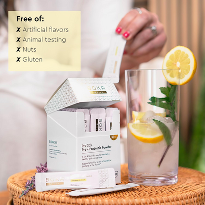 Pro Stix Pre + Probiotic Powder beside lemon water; its free of flavors, nuts, and gluten.