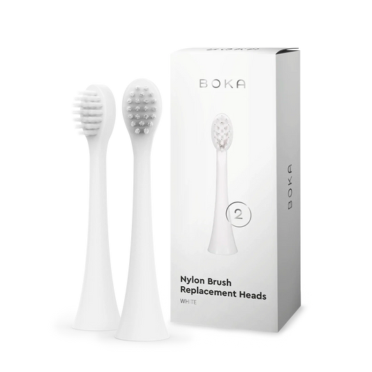 Two kids sonic toothbrush replacement heads stand beside a Boka 168手机澳洲5网 replacement heads box.